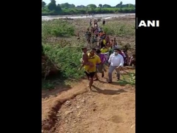 The rescued child being carried by the team in Boudh, Odisha. Photo/ANI