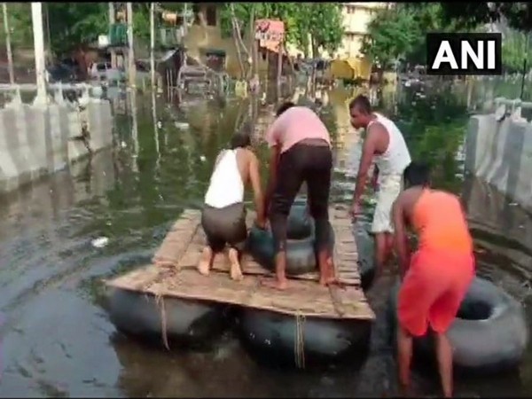 Locals of Rajendra Nagar constructed a makeshift boat to travel through flooded streets on Saturday. Photo/ANI