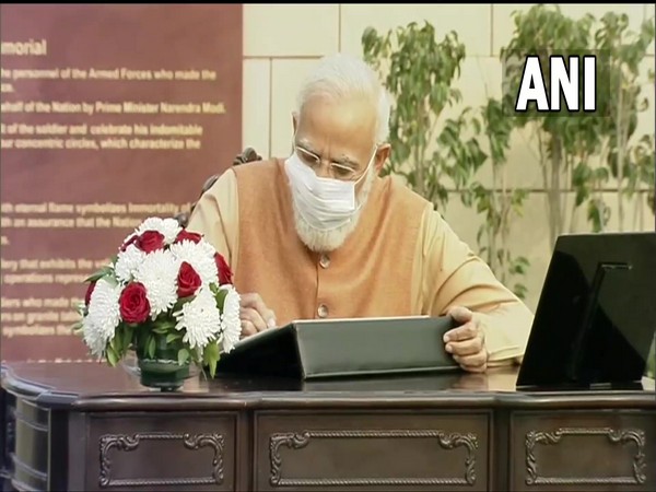 Prime Minister Narendra Modi signs the visitors' book at the National War Memorial. (Photo/ ANI)