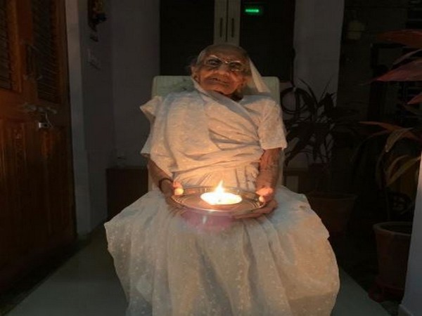 Prime Minister Narendra Modi's mother, Heeraben, with a diya on Sunday night. Photo/ANI