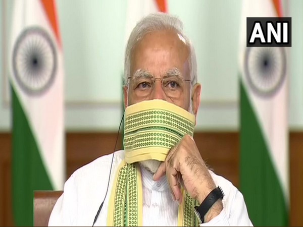 Prime Minister Narendra Modi donning a traditional 'gamcha' during interaction with Sarpanchs from across the nation. Photo/ANI