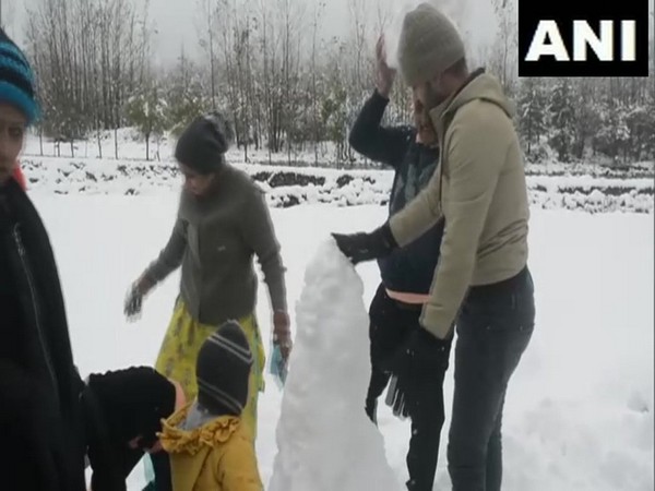 Tourists enjoy snowfall in Pahalgam