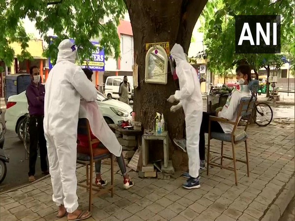 Two brothers re-open their roadside barbershop in Panchkula, wear PPE kits