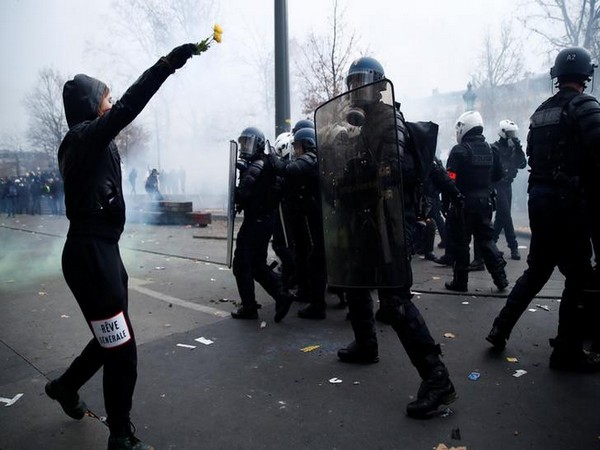 A protestor clashes with police during protest against planned pension reform in Paris on Thursday.