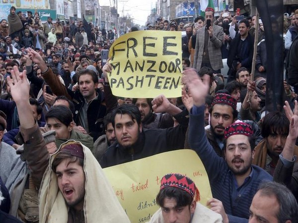 Supporters of PTM hold signs as they chant slogans during country-wide protests over the arrest of their leader and student activist Manzoor Pashteen, in Quetta