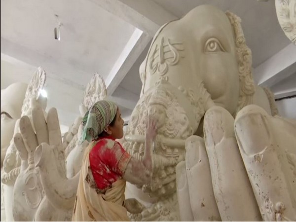 An artisan giving final touches to Lord Ganesha idol in Hyderabad. (ANI)