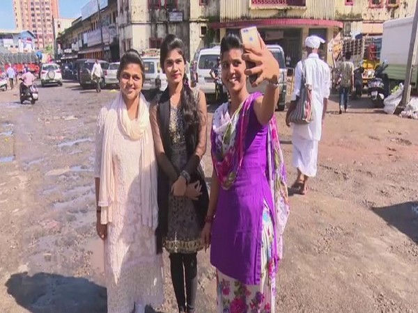 People participating in 'Selfie with Potholes' campaign in Mangaluru on Friday.