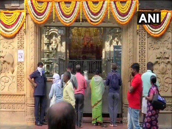 Devotees offering prayers outside the Dagdusheth Halwai Temple in Pune on Tuesday. Photo/ANI