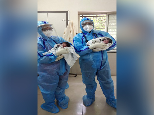 Doctors at Pune's Municipal corporation hospital holding newly born babies.