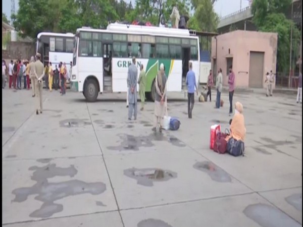 Stranded people from Kashmir at a bus stand in Amritsar on Sunday. Photo/ANI