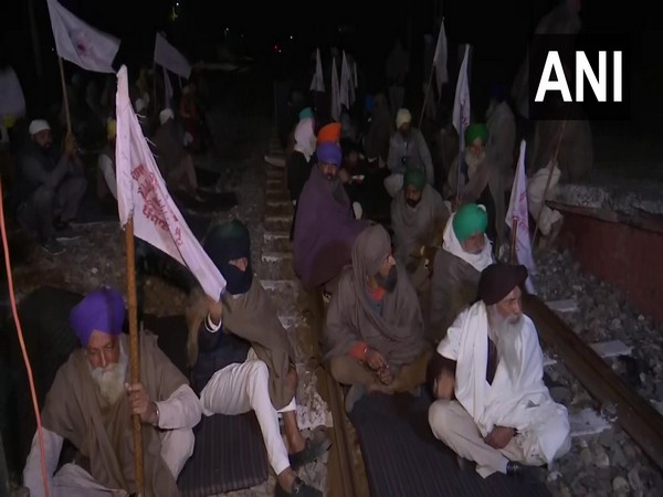 Kisan Mazdoor Sangharsh Committee members block railway tracks in Amritsar's Jandiala Guru on Monday night to protest against the recently enacted farm laws. (Photo/ANI)