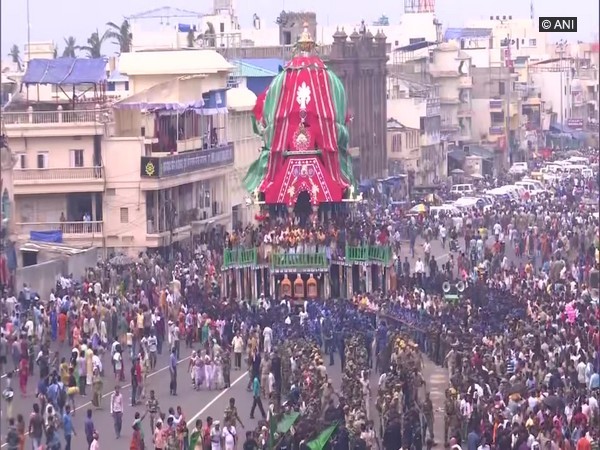 Several devotees pulling the rath from the place of its construction to the Lion's gate of Shree Jagannath Temple