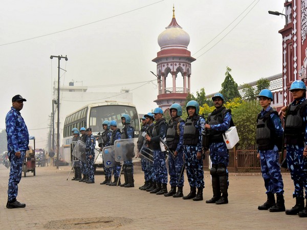 Security personnel stand guard near the Aligarh Muslim University during the protest against Citizenship Amendment Act, 2019, in Aligarh on Saturday. 