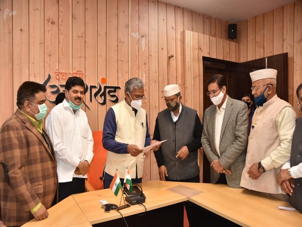 Visual of former Uttarakhand CM Harish Rawat meeting Trivendra Singh Rawat (Photo/ANI)