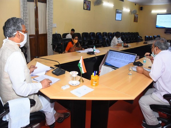 Uttarakhand Chief Minister Trivendra Singh Rawat holding with RDMC officials