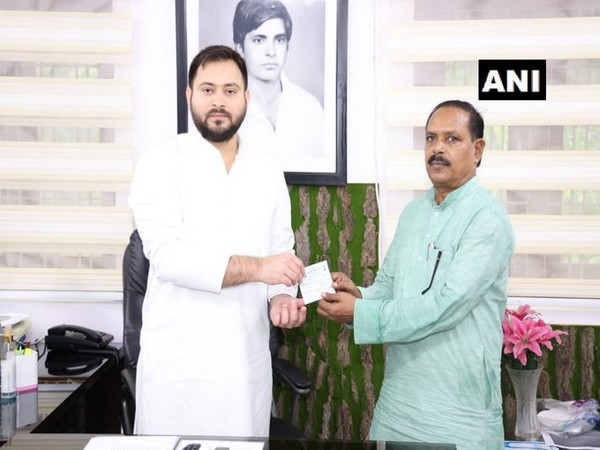 RJD leader Tejashwi Yadav inducting Bihar BSP unit chief Bharat Bind into RJD. (Photo/ANI)