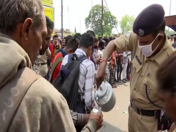 An RPF personnel serving tea to the stranded passengers. Photo/ANI