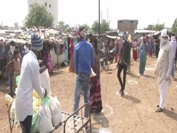 RSS volunteers distributing food packets, grocery kits among poor people in Nagpur on Sunday. Photo/ANI