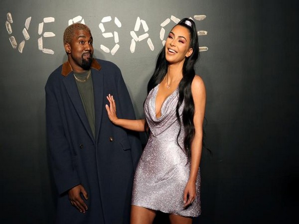 Kanye West and Kim Kardashian pose for a photo before attending the Versace presentation in New York