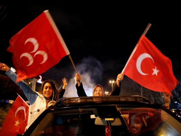 Supporters of Erdogan's AK party wave flags in Istanbul on Sunday