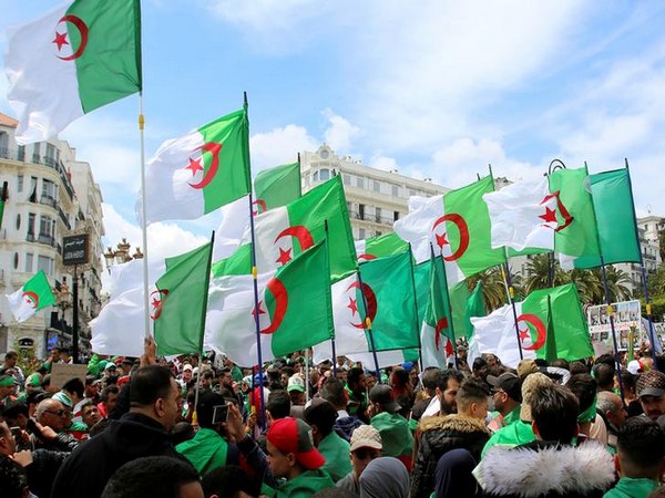 People carry Algeria national flags
