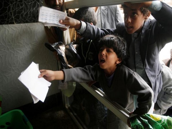 Boys react as they wait to have their food at a Charity Kitchen in Yemen (Source: Reuters) 