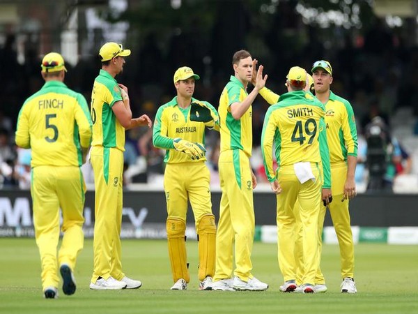 Australia's Jason Behrendorff celebrates with teammates after taking the wicket of England's Moeen Ali