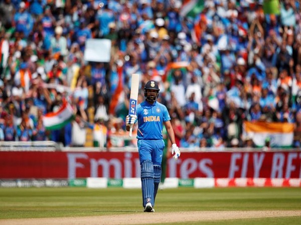 Indian batsman Rohit Sharma celebrates his half-century against Bangladesh