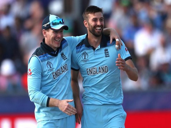 England skipper Eoin Morgan (left) with pacer Mark Wood (right) 