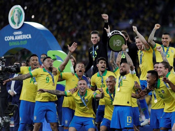 Brazil football team with the 2019 Copa America trophy after defeating Peru by 3-1 at Maracana Stadium in Rio de Janeiro on Sunday.