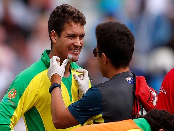 Australia's Alex Carey receives medical attention after being struck on the helmet by the ball off England's Jofra Archer