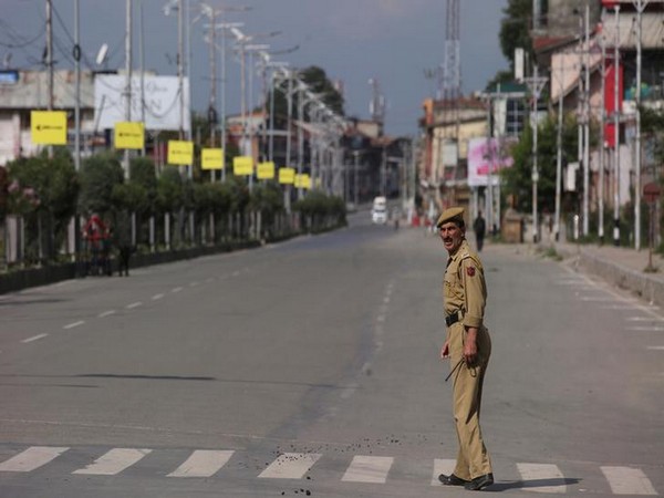 A policeman crosses an empty road during restrictions in Kashmir on Monday. Photo/Reuters