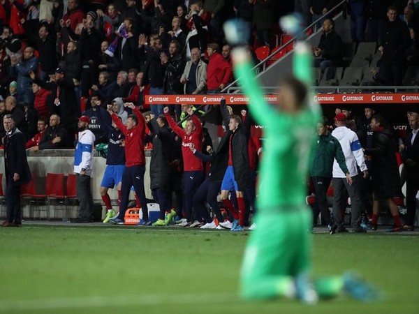 The Czech Republic coaching staff and players on the bench celebrate at full time 