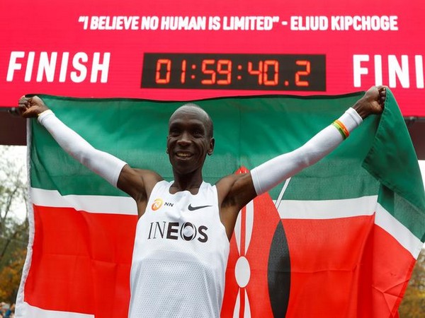 Kenya's Eliud Kipchoge, the marathon world record holder, celebrates after a successful attempt to run a marathon in under two hours in Vienna