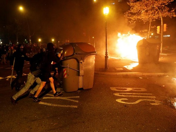 Demonstrators push the trash bin during a protest near Catalan Interior Ministry in Barcelona on Wednesday. Photo/ANI