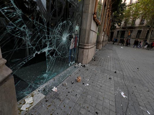 A shop window is shattered during clashes in Catalonia's general strike in Barcelona