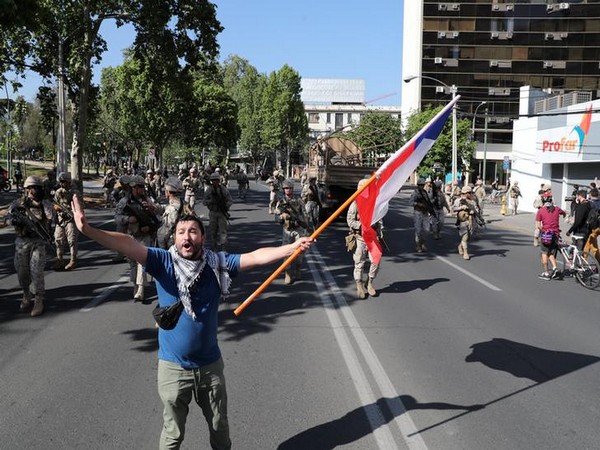 A protester waves a flag during a protest  in Santiago, Chile 