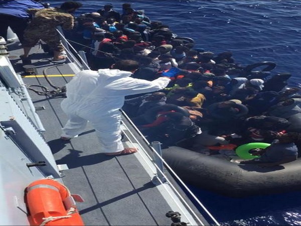 Migrants in a dinghy are rescued by Libyan coast guards in the Mediterranean Sea off the coast of Libya,