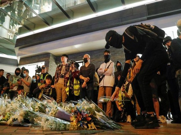 Flowers being placed at a makeshift memorial built for those injured in the anti-government protests in Hong Kong