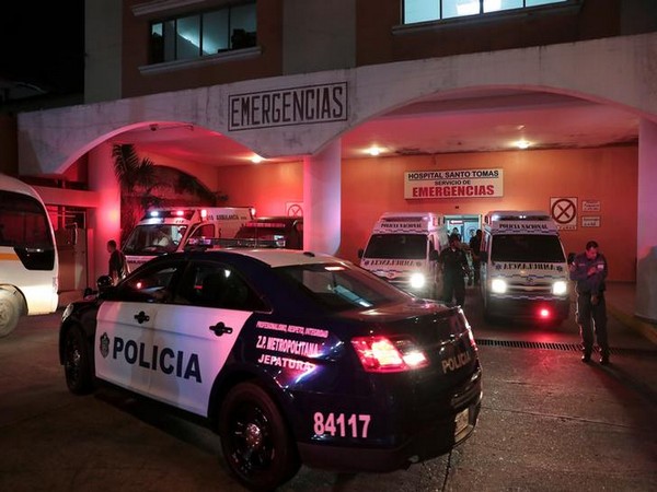 A police car is seen outside a hospital where injured inmates were taken following a shootout among inmates at La Joyita prison in Honduras on Sunday
