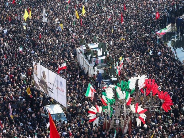 People attend a funeral procession for Iranian Major-General Qassem Soleimani, head of the elite Quds Force, and Iraqi militia commander Abu Mahdi al-Muhandis in Tehran on Monday.