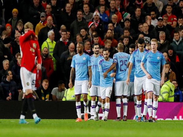 Manchester City's Riyad Mahrez celebrates scoring their second goal with teammates against Manchester United 