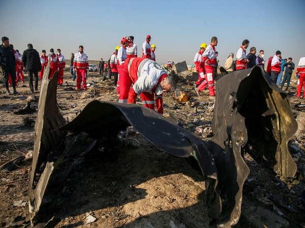 Red Crescent workers check the debris from the Ukraine International Airlines plane, that crashed after take-off from Iran's Imam Khomeini airport, on the outskirts of Tehran, Iran January 8, 2020