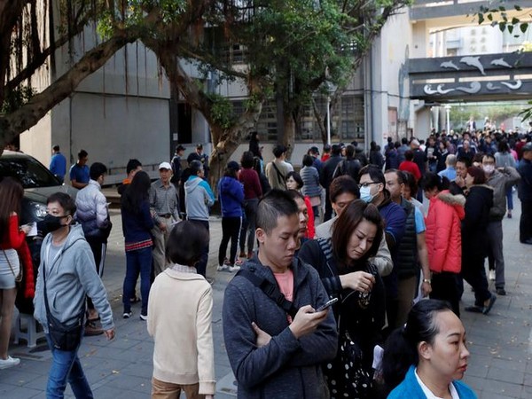 People line up at a polling station during general elections in New Taipei City, Taipei, Taiwan