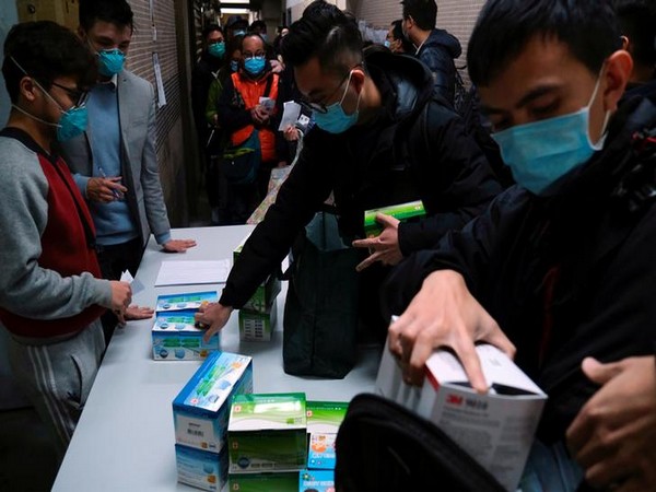 Customers queue to buy facial masks to prevent an outbreak of a new coronavirus in Hong Kong.