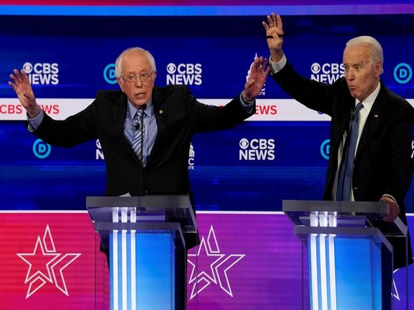 Democratic candidates Senator Bernie Sanders and former Vice President Joe Biden brush hands during the Democratic 2020 presidential debate in South Carolina.
