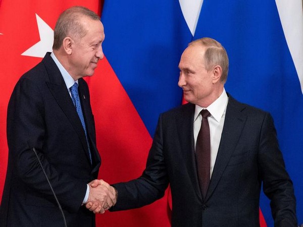 Russian President Vladimir Putin and Turkish President Tayyip Erdogan shake hands during a news conference following their talks in Moscow.