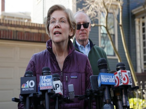 Senator Elizabeth Warren talking to reporters outside her house in Massachusetts. 