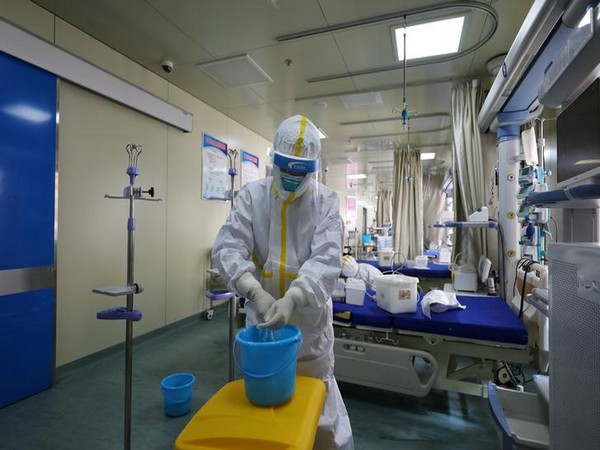 Medical workers in protective suits disinfect an intensive care unit (ICU) ward at a hospital