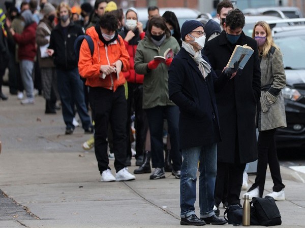 A person reads a book while standing in line for a mobile COVID-19 testing unit as the Omicron continues to spread in Manhattan, New York City, US. (Photo Credit: Reuters)